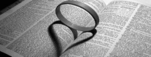 circular-ring-in-the-center-of-a-book-with-a-heart-shaped-shadow